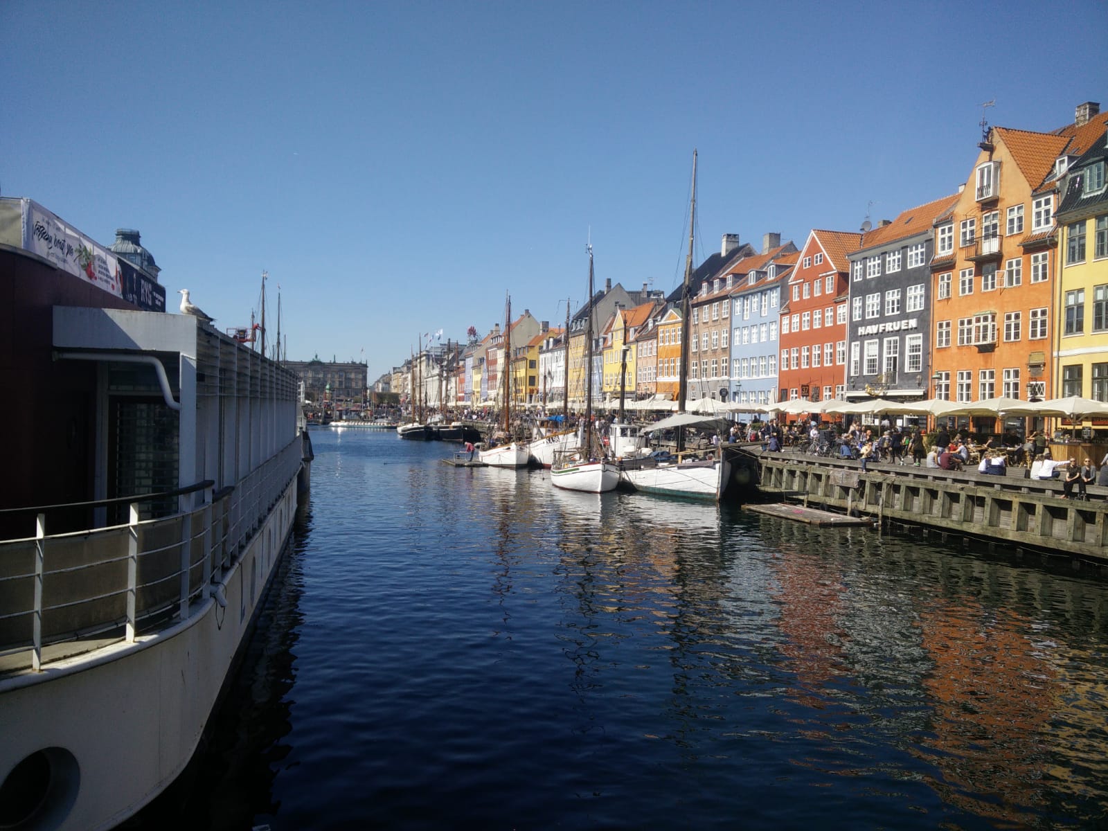 Colourful Nyhavn buildings and moored boats beside the canal in Copenhagen