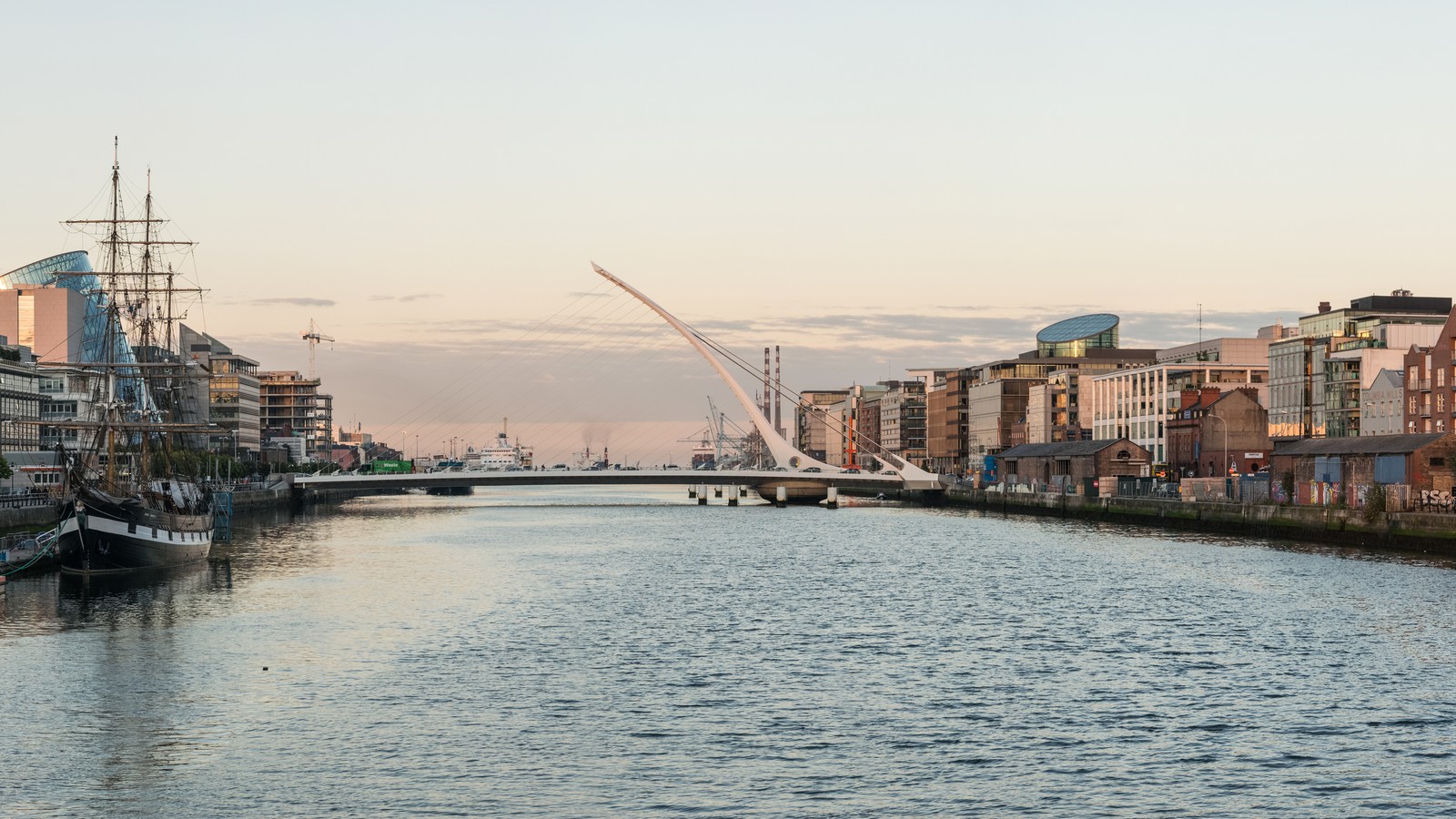 The River Liffey and Samuel Beckett Bridge beside Dublin Docklands buildings