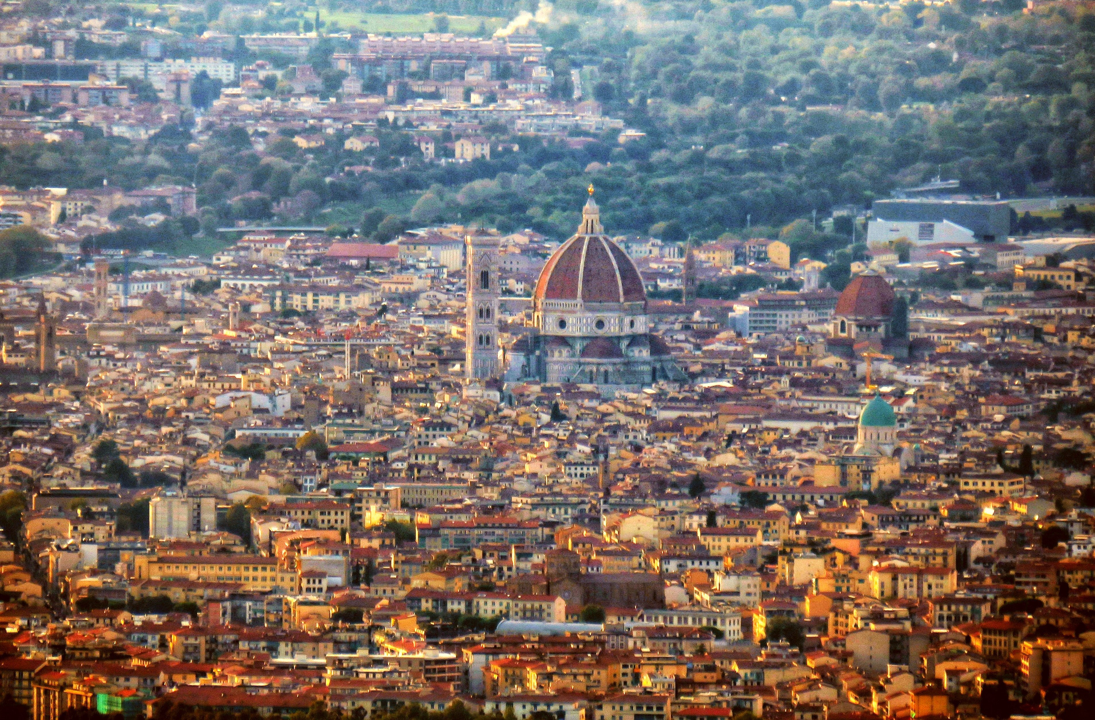 Florence rooftops and the cathedral dome seen across the city from the hills