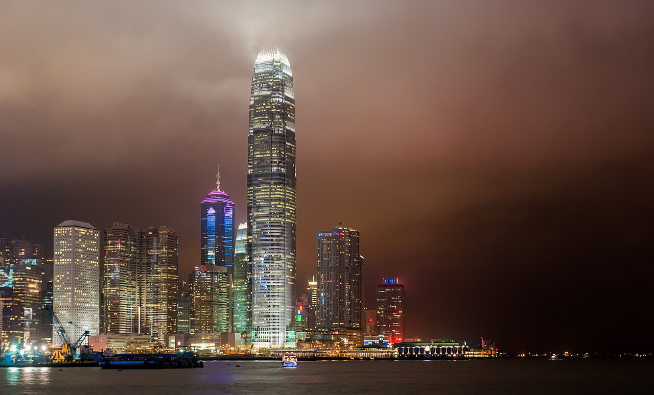 Illuminated Central skyline and the tall IFC tower beside Victoria Harbour at night