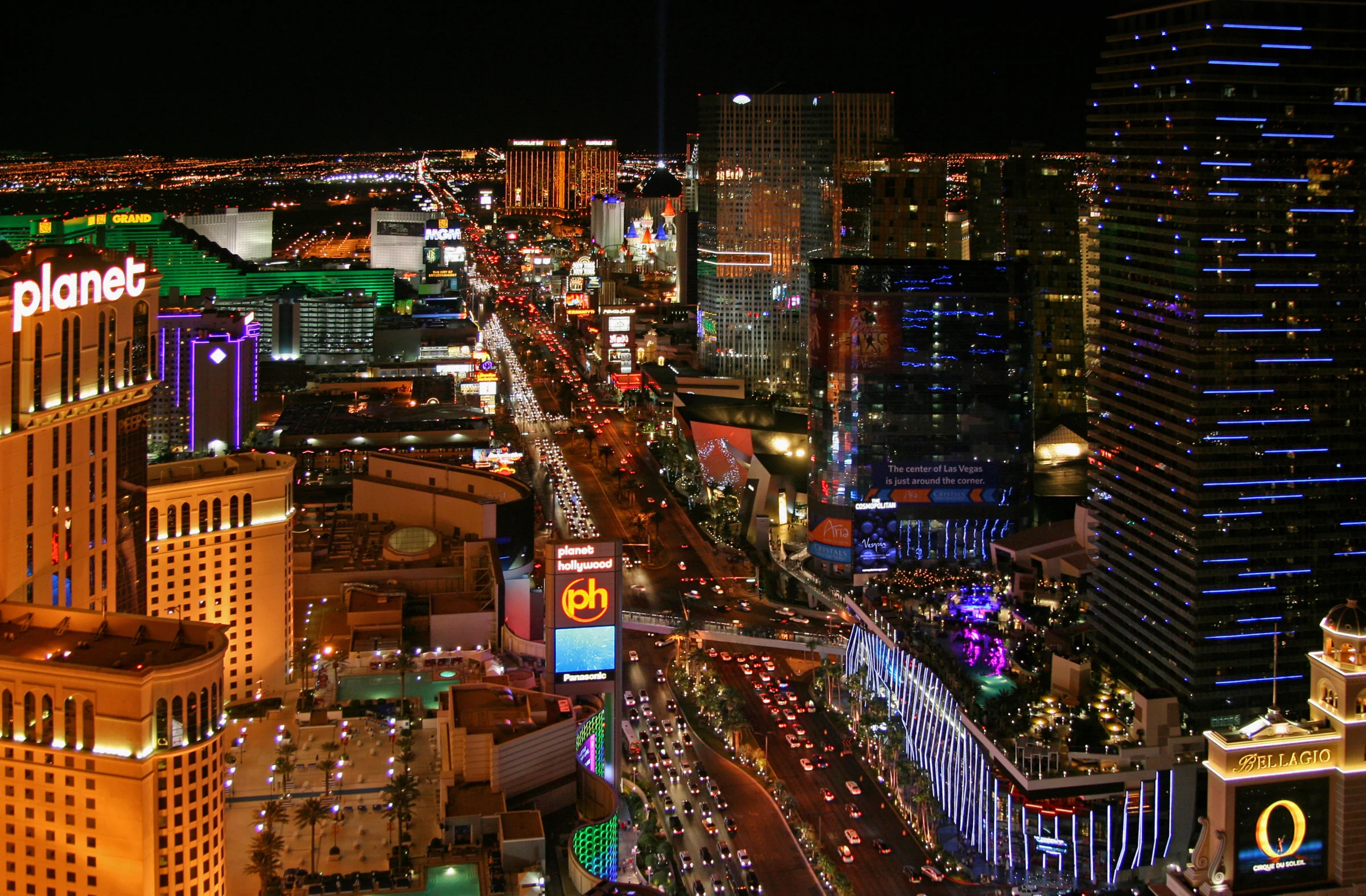 Historical night view down the Las Vegas Strip with lit hotel towers and traffic