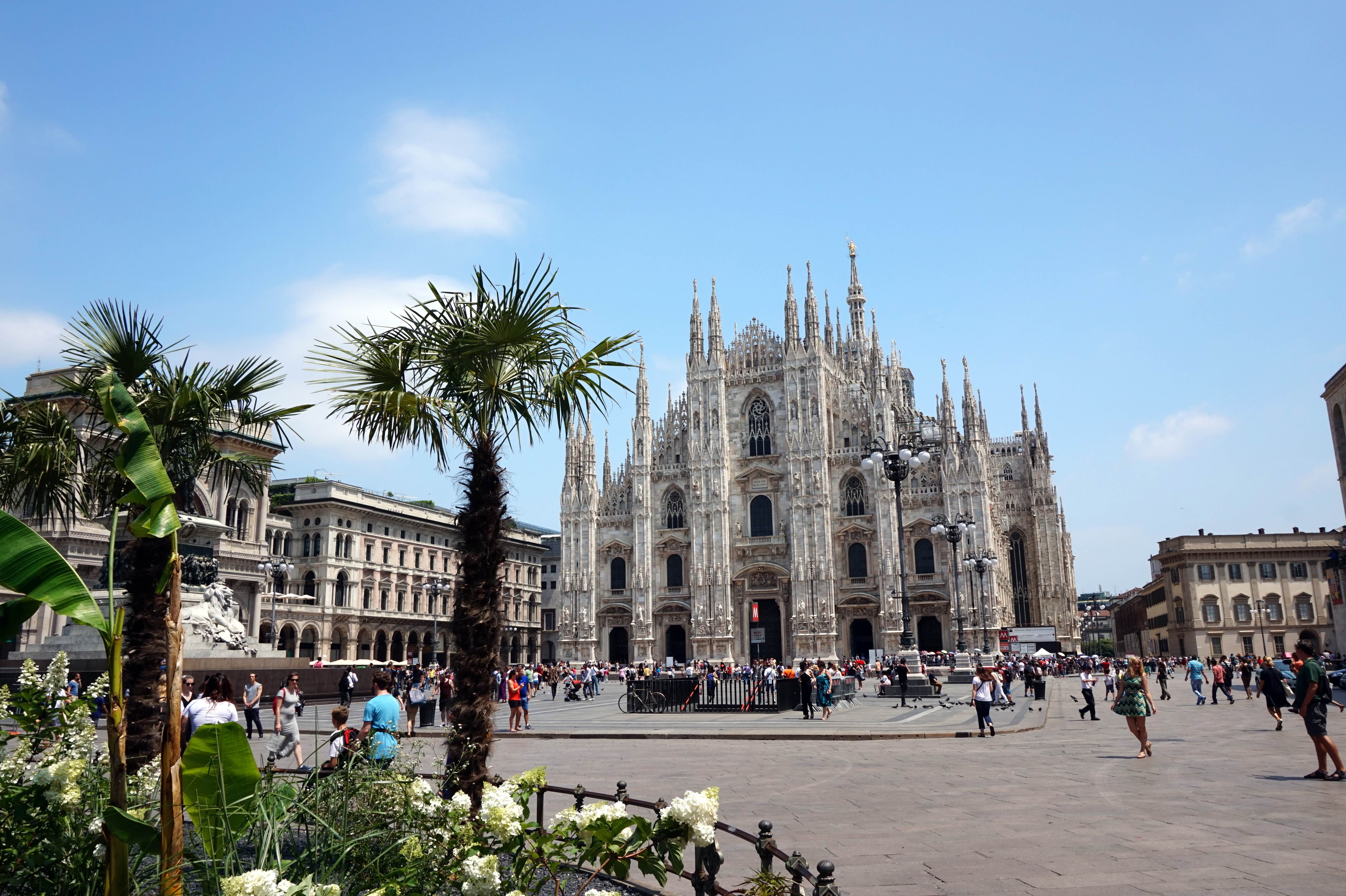 The ornate facade and spires of Milan Cathedral above the square