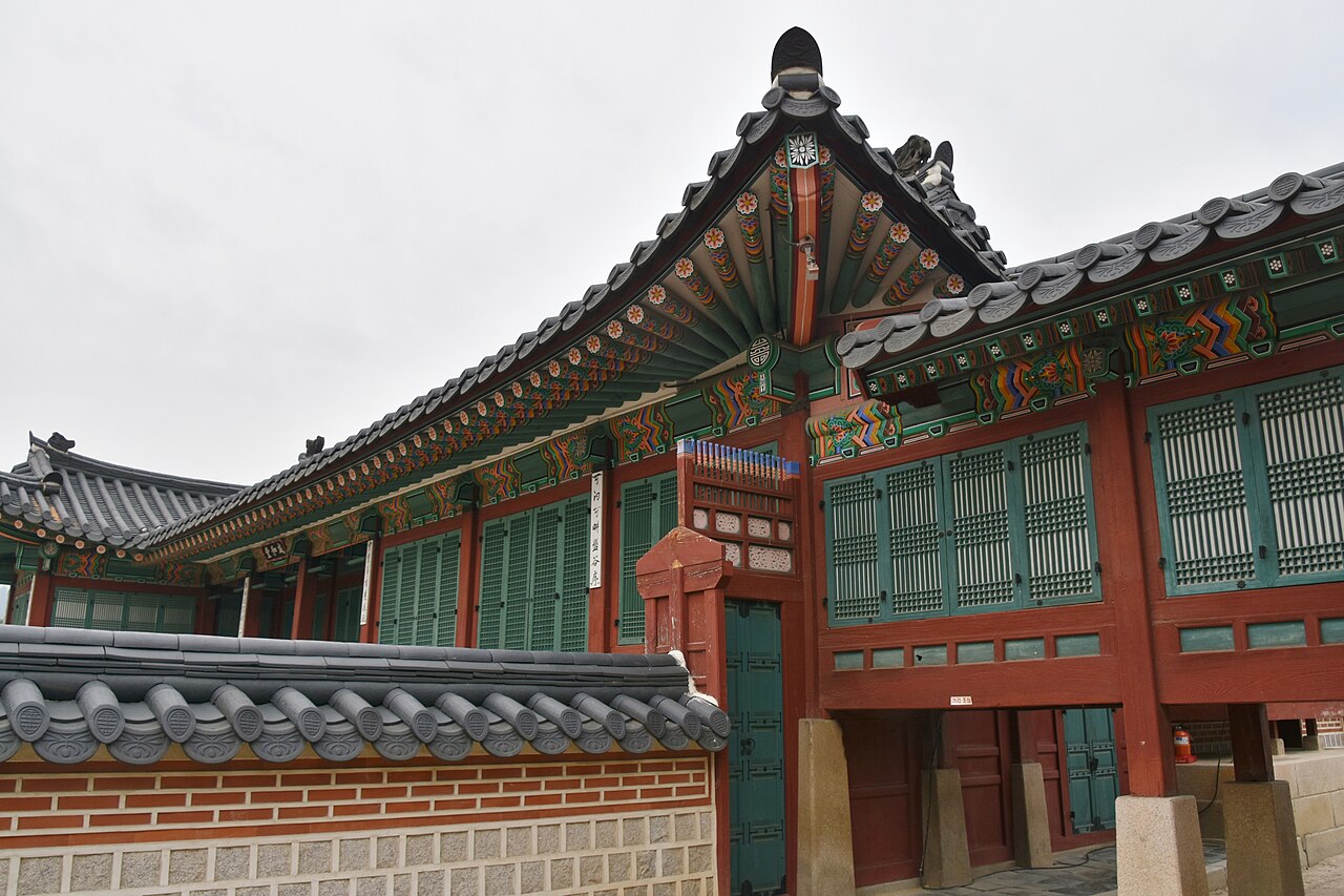Painted wooden eaves and tiled roofs of a building within Seoul's Gyeongbokgung Palace