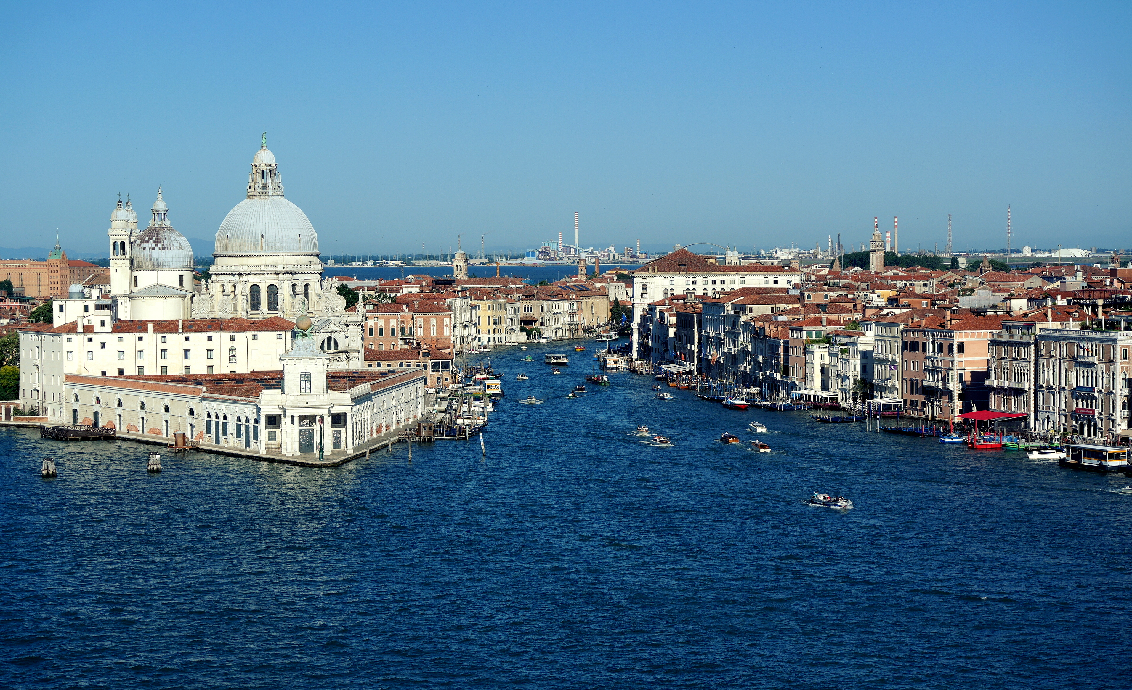 Grand Canal entrance with Santa Maria della Salute dome, waterfront palaces and boats in Venice